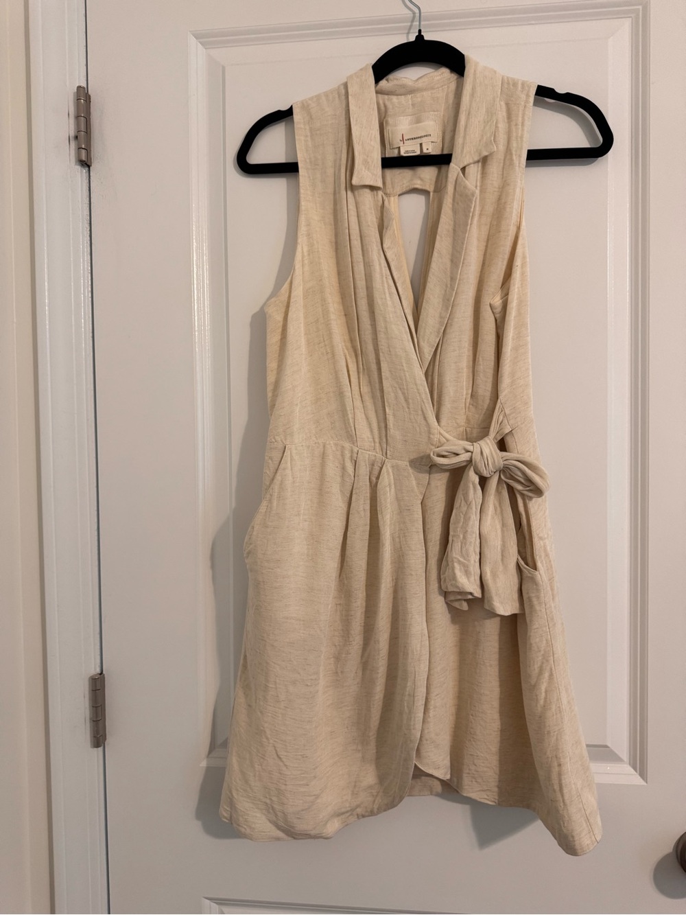 Anthropologie Sleeveless Cream Wrap-Front dress.